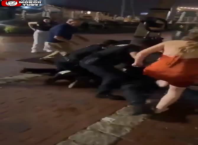 Video :After attempting to steal a police officer's pistol at a wedding, a woman is struck unconscious